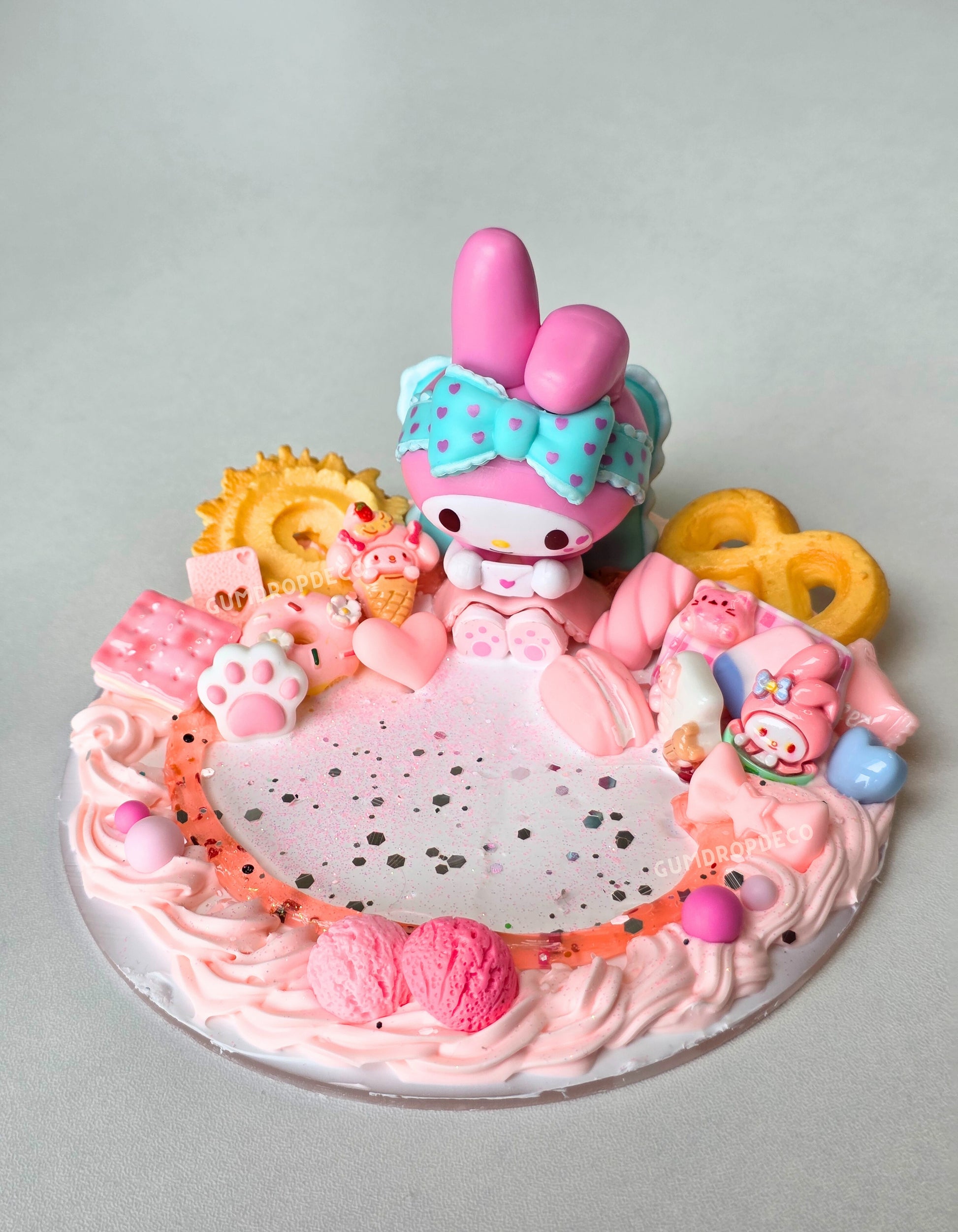 Custom decoden phone stand with Sanrio themes – Kuromi, My Sweet Piano & My Melody or custom your own. Handmade design, cute display & perfect for your desk or bedside.