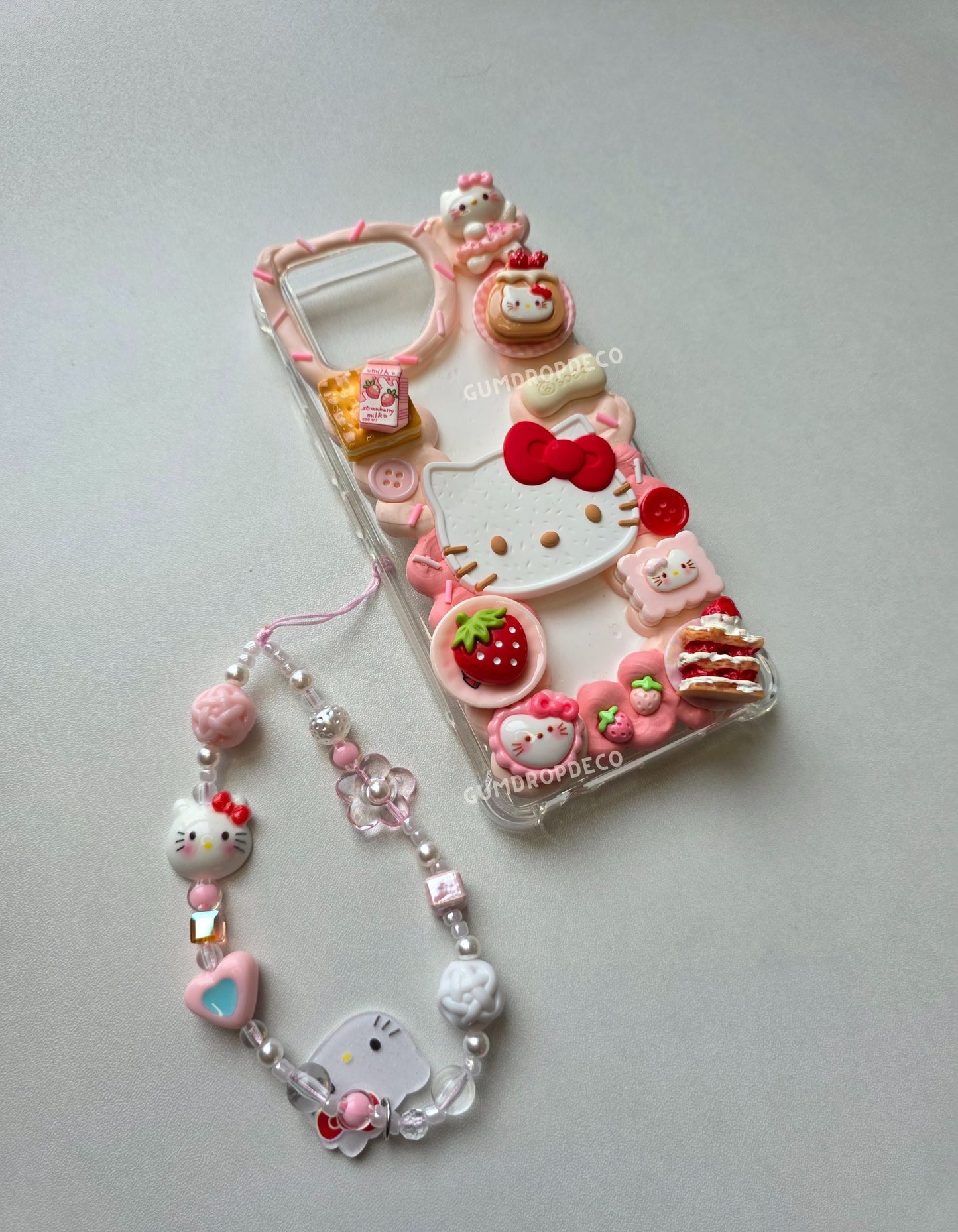 Cute decoden phone case decorated with Sanrio characters and 3D charms. Sanrio Hello Kitty