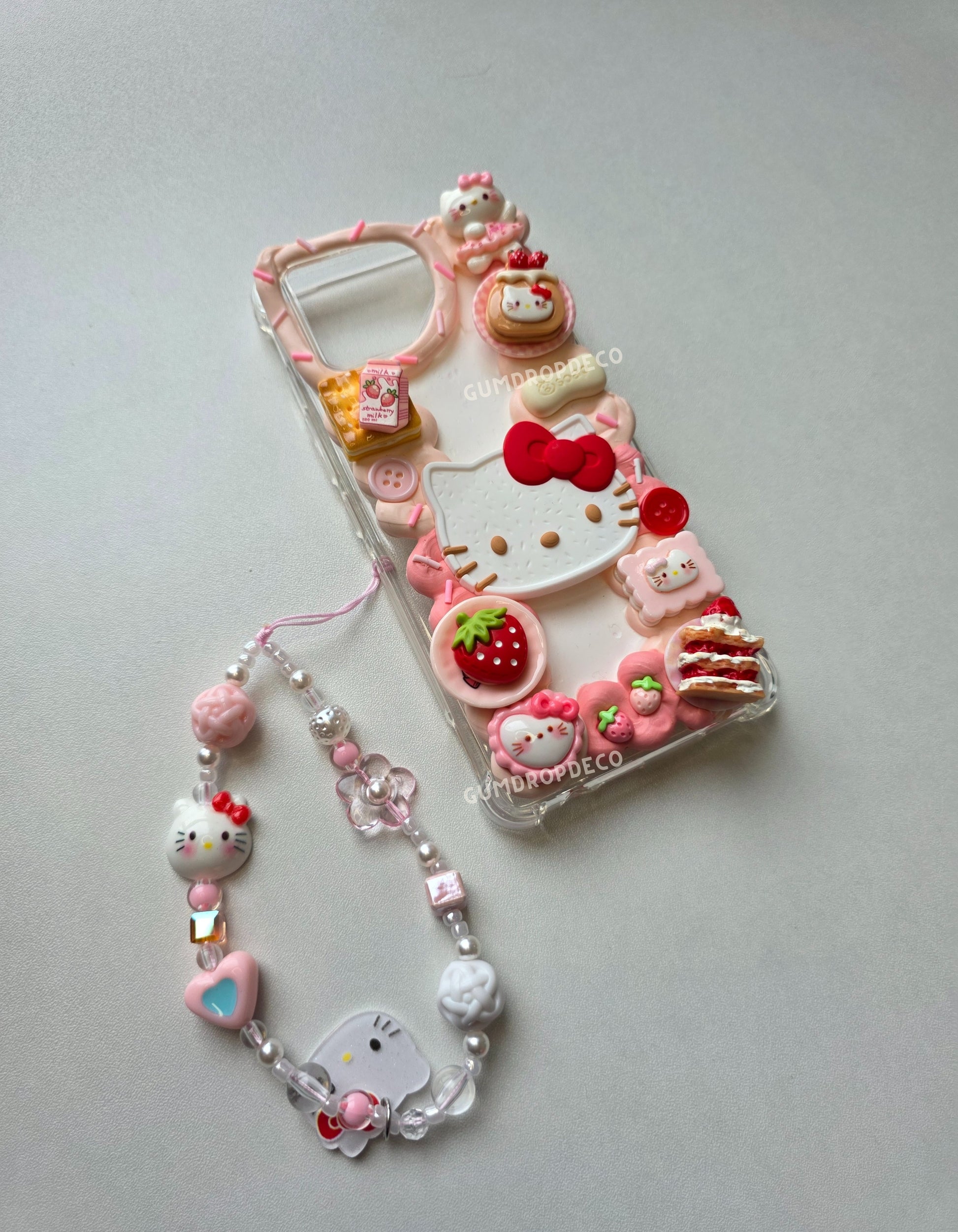 Cute decoden phone case decorated with Sanrio characters and 3D charms. Sanrio Hello Kitty